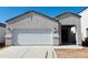 Charming single-story home featuring a bright white exterior, attached two-car garage, and covered porch at 5094 E Umber Rd, San Tan Valley, AZ 85143