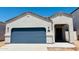 Charming single-story home featuring a blue garage door and a welcoming front entry, set against a clear blue sky at 5094 E Umber Rd, San Tan Valley, AZ 85143