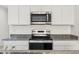 Close up of the stainless steel oven, microwave and granite countertops at 5094 E Umber Rd, San Tan Valley, AZ 85143