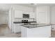 Open concept kitchen with island and stainless steel microwave and range at 5094 E Umber Rd, San Tan Valley, AZ 85143