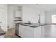 Kitchen island with sink and granite countertops is visible in an open concept home at 5094 E Umber Rd, San Tan Valley, AZ 85143