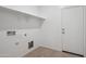 A well-lit laundry room with open shelving and a neutral-toned tile floor at 5094 E Umber Rd, San Tan Valley, AZ 85143