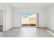 Living room with tile floor, white walls, and sliding glass doors to backyard at 5094 E Umber Rd, San Tan Valley, AZ 85143