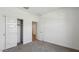 A minimalist bedroom featuring a closet with paneled sliding doors and neutral carpeting at 5865 E Axle Ln, San Tan Valley, AZ 85140
