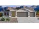 Charming single-story home featuring a 3-car garage and desert landscaping at 5865 E Axle Ln, San Tan Valley, AZ 85140