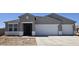 Charming single-story home featuring a two-car garage and neutral-colored stucco exterior under a clear, blue sky at 5865 E Axle Ln, San Tan Valley, AZ 85140