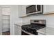 Stylish kitchen with stainless steel gas range, microwave, and quartz countertops at 5865 E Axle Ln, San Tan Valley, AZ 85140