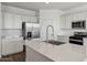 Modern kitchen with stainless steel appliances, white cabinets, and a large island at 5865 E Axle Ln, San Tan Valley, AZ 85140