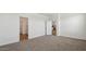 Spacious main bedroom with plush carpeting and access to bathroom and kitchen at 5865 E Axle Ln, San Tan Valley, AZ 85140