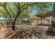 A spacious backyard shaded by large trees and an outdoor covered patio at 620 N Entrada St, Chandler, AZ 85226
