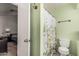 A glimpse of a bathroom with a toilet and a shower with a curtain at 620 N Entrada St, Chandler, AZ 85226