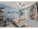 Comfortable bedroom with blue walls, a ceiling fan, and plenty of storage space at 620 N Entrada St, Chandler, AZ 85226