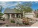 Inviting home exterior featuring lush desert landscaping, a well-manicured yard, and a two-car garage at 620 N Entrada St, Chandler, AZ 85226