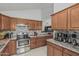 Well-equipped kitchen with stainless steel appliances, tiled backsplash, and ample cabinet space at 620 N Entrada St, Chandler, AZ 85226