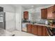 Functional kitchen with stainless steel sink, plentiful cabinets, and stylish tile backsplash at 620 N Entrada St, Chandler, AZ 85226