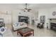 Spacious living room with tile flooring, a fireplace, and a ceiling fan for added comfort at 620 N Entrada St, Chandler, AZ 85226