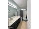 Bathroom with a double sink vanity, framed mirror and shower with a bathtub at 6808 W Maldonado Rd, Laveen, AZ 85339
