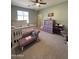 Cozy bedroom featuring a comfortable bed, sitting chair, and ample natural light at 6808 W Maldonado Rd, Laveen, AZ 85339