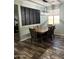 Stylish dining room with wood-look tile flooring and a modern light fixture at 6808 W Maldonado Rd, Laveen, AZ 85339