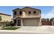 Inviting two-story home featuring a tile roof, two-car garage, and well-maintained landscaping at 6808 W Maldonado Rd, Laveen, AZ 85339