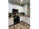 Bright kitchen featuring white cabinetry, granite countertops, and stainless steel appliances at 6808 W Maldonado Rd, Laveen, AZ 85339