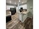 Modern kitchen with white cabinets, granite countertops, and stainless steel appliances at 6808 W Maldonado Rd, Laveen, AZ 85339