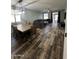 Open-concept dining and living area featuring tile floors and a sliding glass door at 6808 W Maldonado Rd, Laveen, AZ 85339