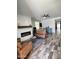 Cozy living room with a fireplace, ceiling fan, and wood-look tile flooring at 6808 W Maldonado Rd, Laveen, AZ 85339