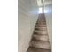 Carpeted stairs ascend past horizontal plank walls to a light-filled upper level at 6808 W Maldonado Rd, Laveen, AZ 85339