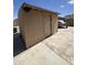 Backyard features a storage shed and covered vehicle at 6808 W Maldonado Rd, Laveen, AZ 85339