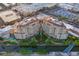 Aerial view showcasing two luxury buildings with a serene riverwalk, landscaping and pool area at 7175 E Camelback Rd # 902, Scottsdale, AZ 85251