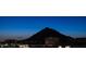 Distant skyline view featuring buildings and a mountain range against a dusk sky at 7175 E Camelback Rd # 902, Scottsdale, AZ 85251