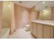 A cozy bathroom showcases a vanity with sink, a toilet, and a bathtub with a shower, offering comfortable functionality at 7175 E Camelback Rd # 902, Scottsdale, AZ 85251
