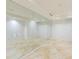 Bright fitness room featuring mirrored wall and travertine tile flooring at 7175 E Camelback Rd # 902, Scottsdale, AZ 85251