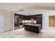 A spacious kitchen features dark wood cabinetry, a center island, and stainless steel appliances, perfect for culinary enthusiasts at 7175 E Camelback Rd # 902, Scottsdale, AZ 85251