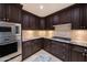 Gourmet kitchen with stainless steel appliances, gas cooktop, and granite counters at 7175 E Camelback Rd # 902, Scottsdale, AZ 85251