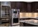 Gourmet kitchen with stainless steel appliances and custom wood cabinetry at 7175 E Camelback Rd # 902, Scottsdale, AZ 85251