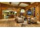 Spacious living room with hardwood floors, wood beams, a fireplace, and comfortable seating at 7175 E Camelback Rd # 902, Scottsdale, AZ 85251