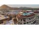 An aerial view featuring a rooftop pool with seating overlooking the city and mountain views at 7175 E Camelback Rd # 902, Scottsdale, AZ 85251