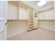 Spacious walk-in closet provides ample storage with custom shelving, rods, and built-in drawers at 7175 E Camelback Rd # 902, Scottsdale, AZ 85251