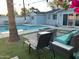 Inviting backyard with a pool, cozy lounge area, and a modern fire pit for outdoor enjoyment at 7635 E Verde Ln, Scottsdale, AZ 85251