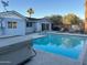 A lovely backyard features a swimming pool and relaxing hot tub for ultimate outdoor living at 7635 E Verde Ln, Scottsdale, AZ 85251