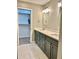 Elegant bathroom featuring double sinks, gray cabinets, and a well-lit vanity with modern fixtures at 7635 E Verde Ln, Scottsdale, AZ 85251