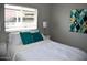 Cozy bedroom with a bright window, plush pillows, and modern artistic decor at 7635 E Verde Ln, Scottsdale, AZ 85251