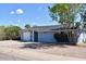 Charming single-story home featuring a well-maintained yard, fresh paint, and an attached one car garage at 7635 E Verde Ln, Scottsdale, AZ 85251