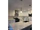 Well-lit kitchen with white cabinetry, stainless steel appliances, and a quartz countertop island at 7635 E Verde Ln, Scottsdale, AZ 85251