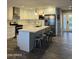Modern kitchen with stainless steel appliances, quartz countertops, and a central island with seating at 7635 E Verde Ln, Scottsdale, AZ 85251