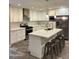 Modern kitchen with white cabinets, stainless steel appliances, and a center island with seating at 7635 E Verde Ln, Scottsdale, AZ 85251