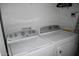 Functional laundry room featuring a modern washer and dryer set, optimized for convenience and efficiency at 7635 E Verde Ln, Scottsdale, AZ 85251