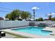 A sparkling in-ground pool is surrounded by a well-maintained patio and a privacy fence at 7635 E Verde Ln, Scottsdale, AZ 85251